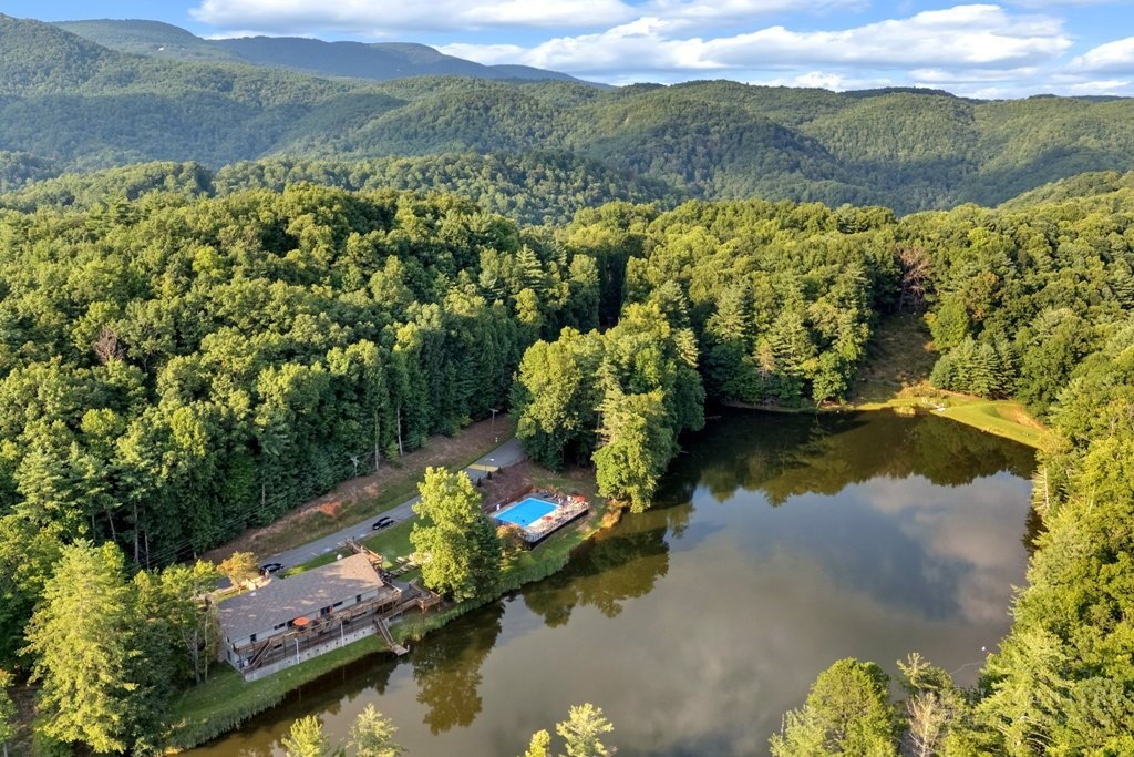 467 Horseshoe Ridge Road East Deep Gap, NC 28618 - Photo 36 of 46 a view of a lake with mountains in the background