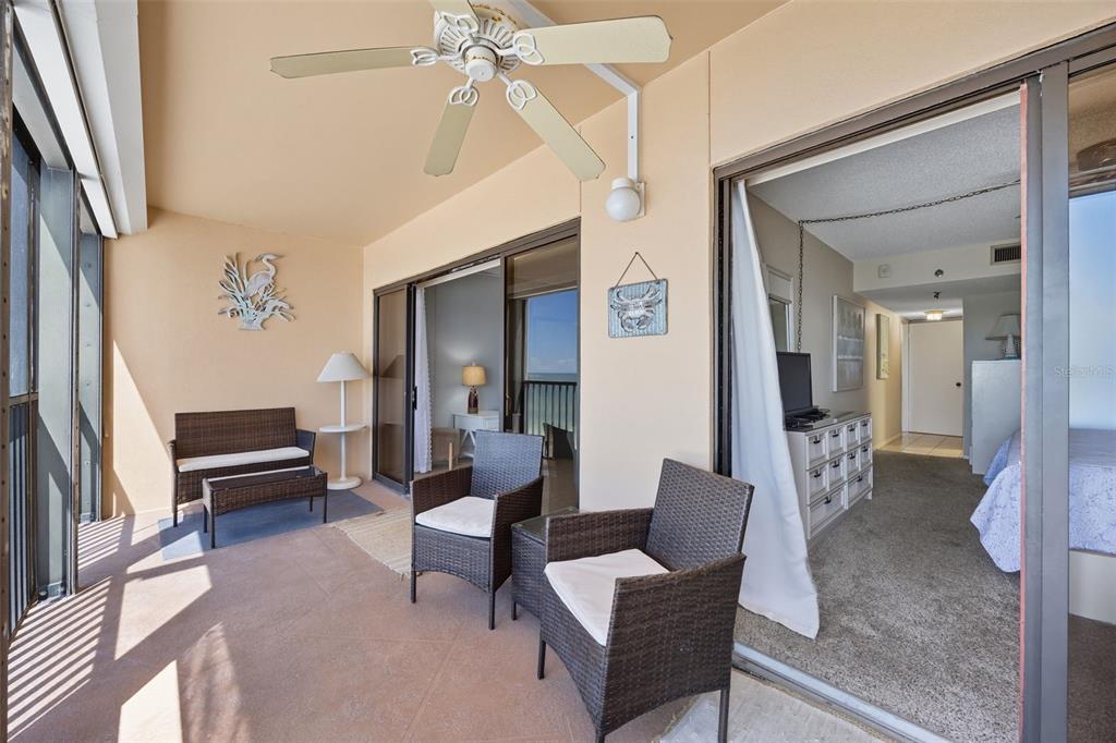 13720 Gulf Boulevard, Unit 609 Madeira Beach, FL 33708 - Photo 12 of 40 a living room with furniture and a chandelier
