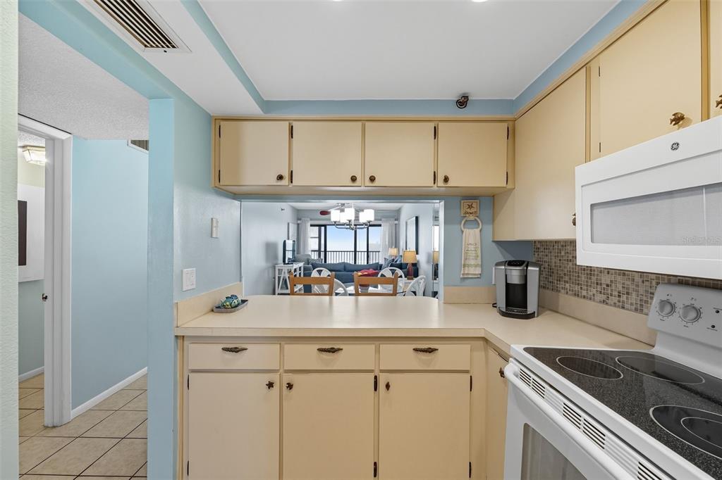 13720 Gulf Boulevard, Unit 609 Madeira Beach, FL 33708 - Photo 16 of 40 a kitchen with a sink and cabinets
