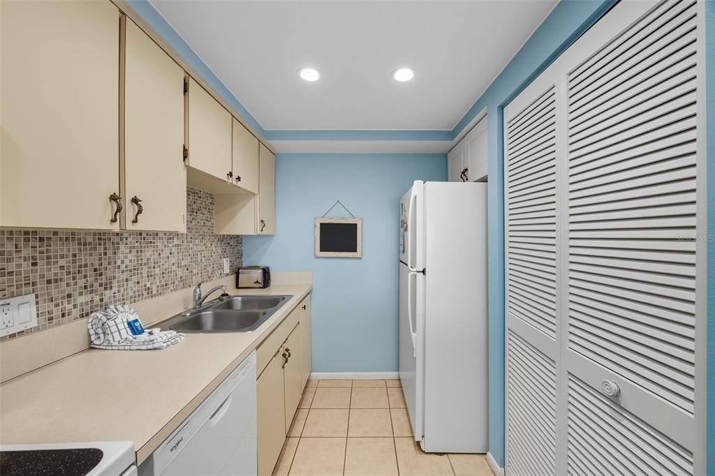 13720 Gulf Boulevard, Unit 609 Madeira Beach, FL 33708 - Photo 17 of 40 a kitchen with a sink and refrigerator