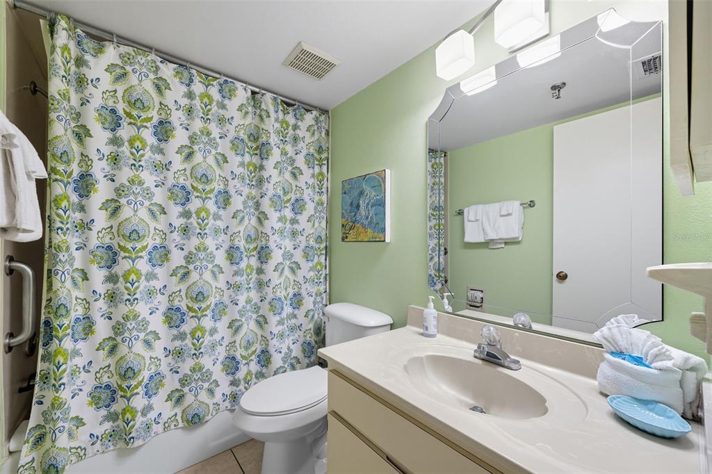 13720 Gulf Boulevard, Unit 609 Madeira Beach, FL 33708 - Photo 22 of 40 a bathroom with a sink toilet and a mirror