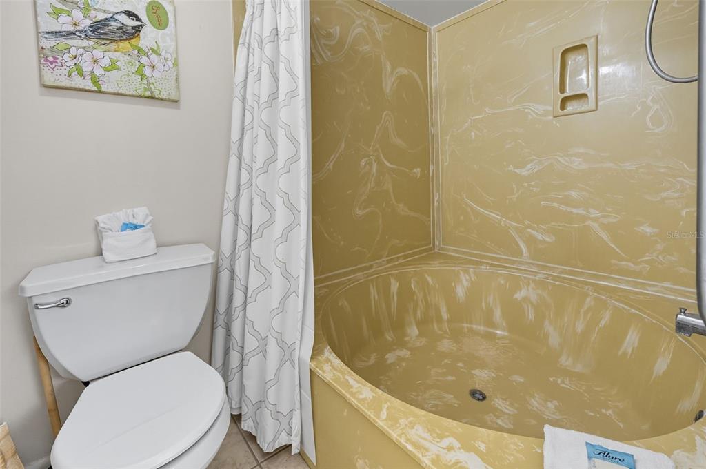 13720 Gulf Boulevard, Unit 609 Madeira Beach, FL 33708 - Photo 26 of 40 a white toilet sitting next to a bath tub