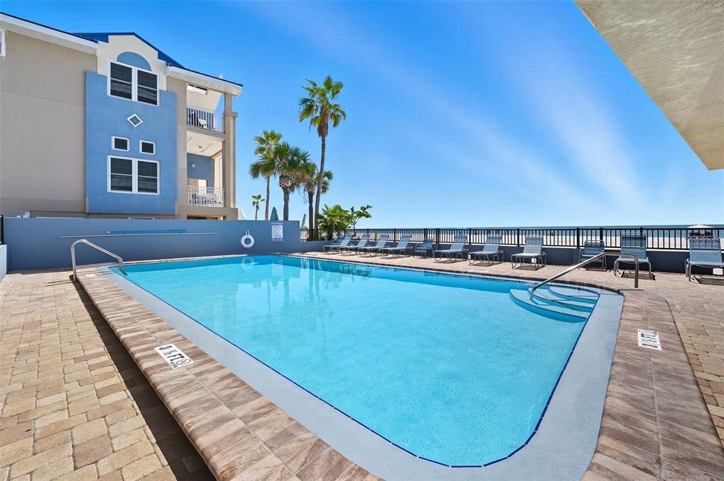 13720 Gulf Boulevard, Unit 609 Madeira Beach, FL 33708 - Photo 4 of 40 a view of swimming pool with outdoor seating