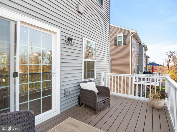 a balcony with wooden floor outdoor seating and wooden floor