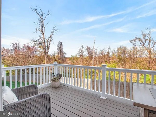 a view of balcony with wooden floor and fence