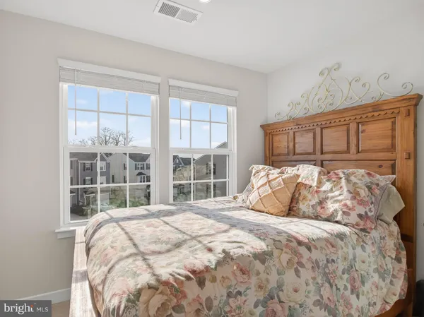 a bedroom with a large bed and a large window