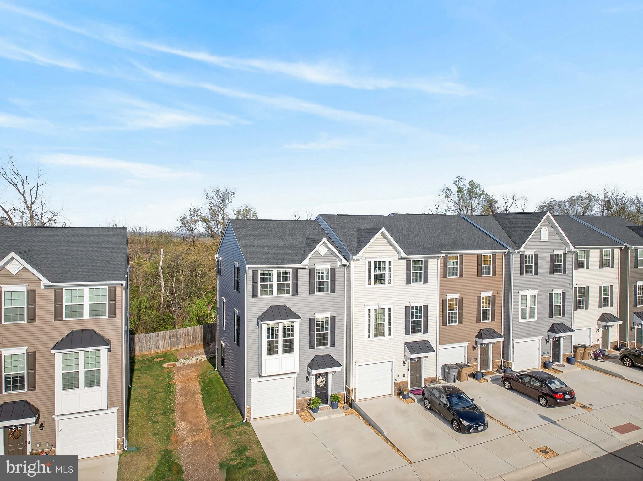 1724 Scenic Loop Culpeper, VA 22701 - Photo 28 of 29 a front view of a residential apartment building with a yard