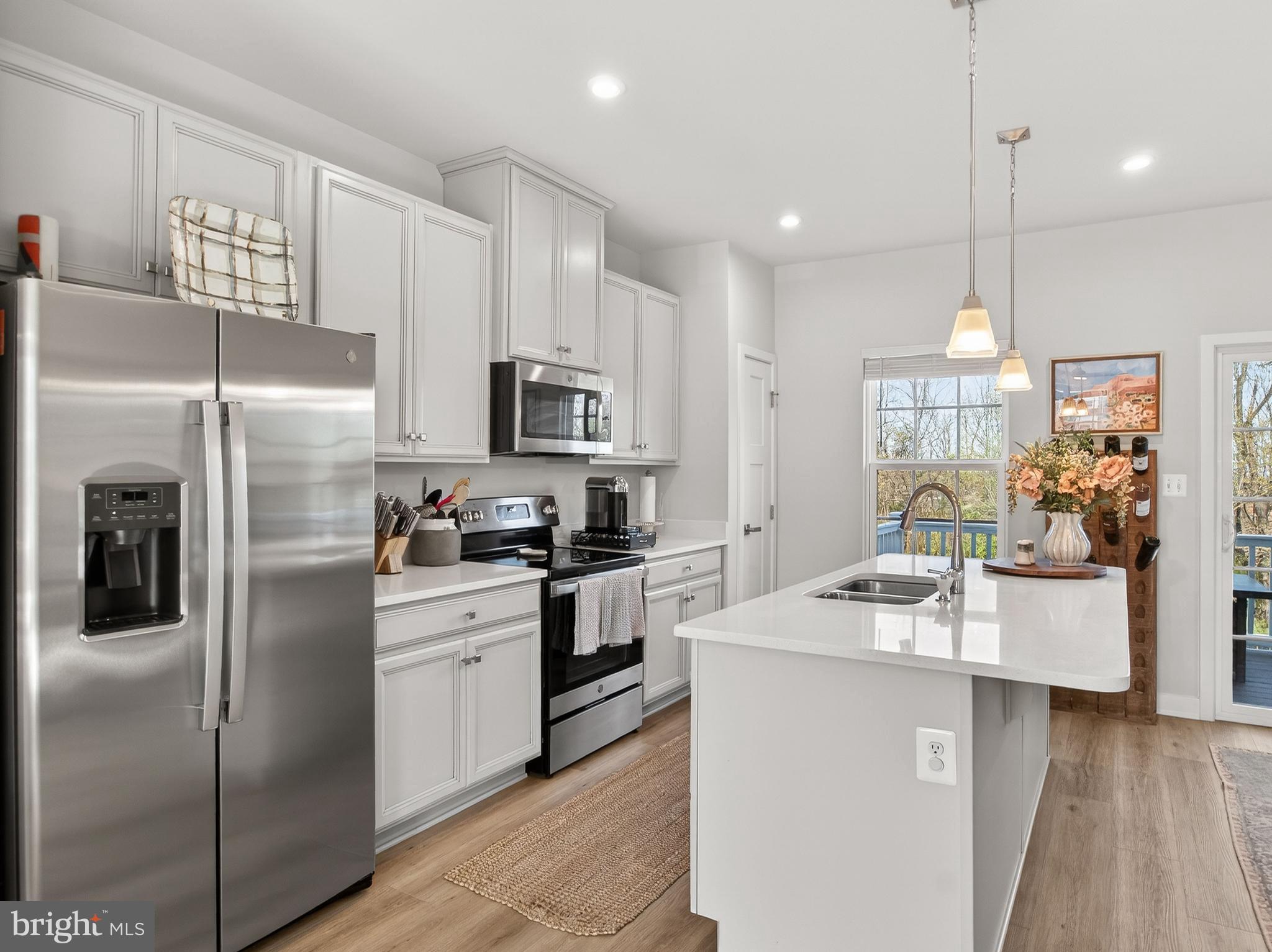 1724 Scenic Loop Culpeper, VA 22701 - Photo 6 of 29 a kitchen with kitchen island granite countertop stainless steel appliances cabinets a sink and a counter top space