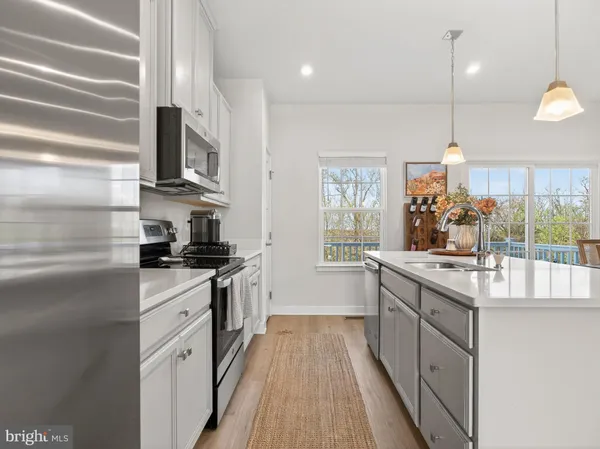 a kitchen with stainless steel appliances granite countertop a sink and stove top oven