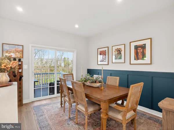 a dining room with furniture and wooden floor