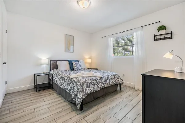 a bedroom with a bed and a window
