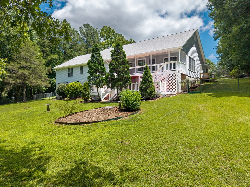 429 Burns Mill Road West Union, SC 29696 - Photo 46 of 49 A spacious backyard with mature trees and a multi-level deck offers serene outdoor living.