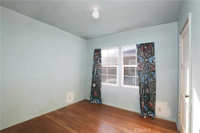 an empty room with windows and closet