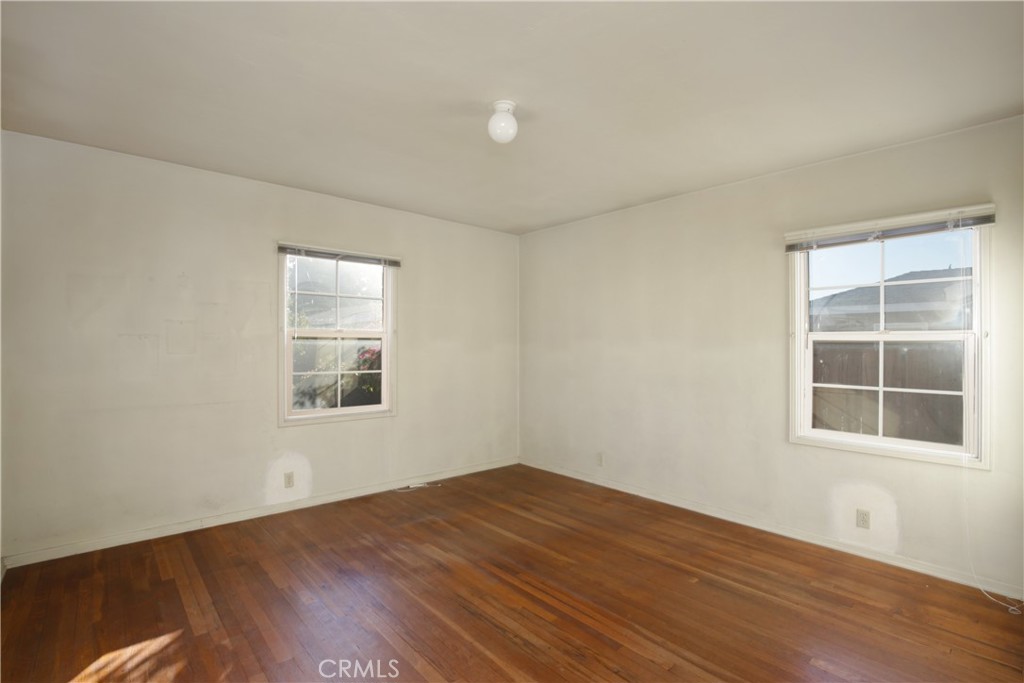 1618 West 9th Street Santa Ana, CA 92703 - Photo 18 of 29 an empty room with wooden floor and windows