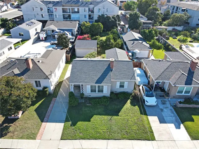 an aerial view of residential houses with yard