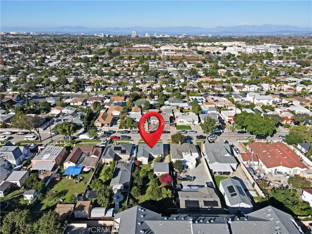 an aerial view of residential houses with outdoor space and street view