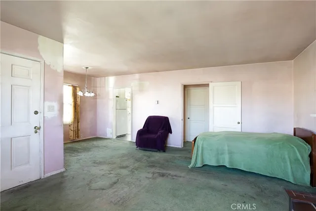 a spacious bedroom with a bed and a couch