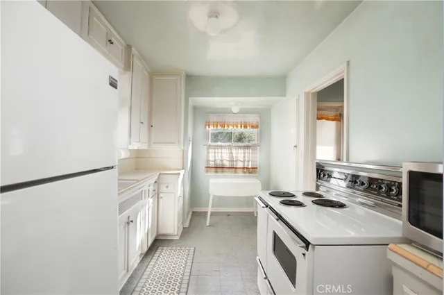 a kitchen with a stove a sink and a refrigerator