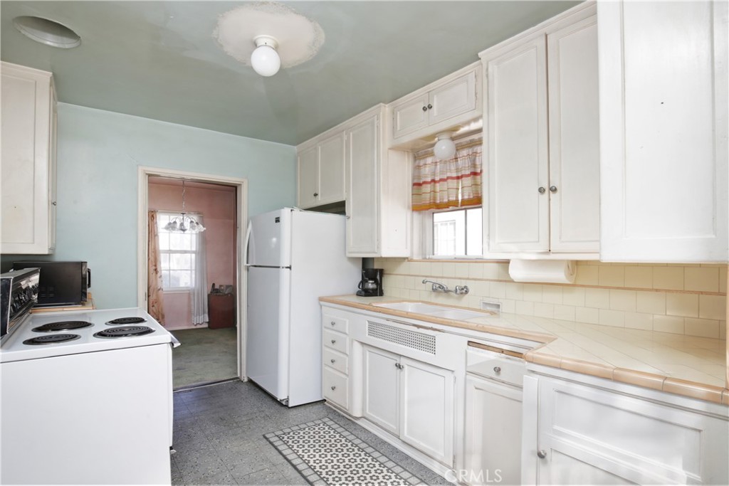 1618 West 9th Street Santa Ana, CA 92703 - Photo 8 of 29 a kitchen with a sink cabinets and window
