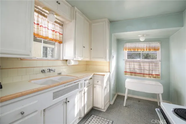 a kitchen with a sink and large window