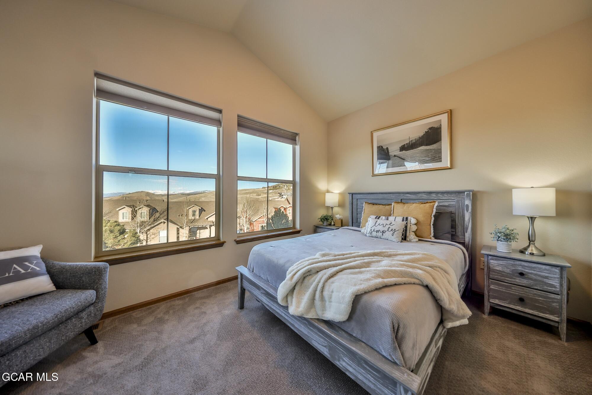 113 Summit Point Lane Granby, CO 80446 - Photo 17 of 43 a bedroom with a bed a couch and a window