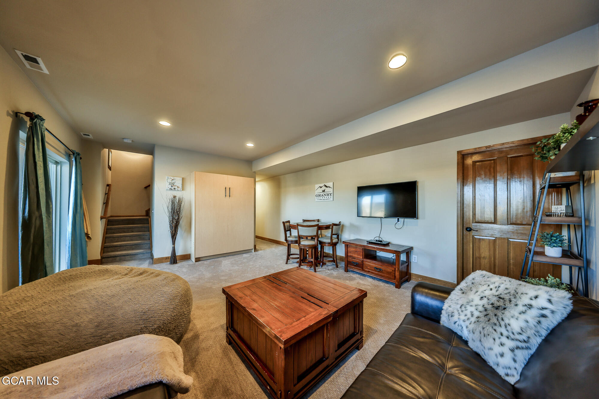 113 Summit Point Lane Granby, CO 80446 - Photo 21 of 43 a living room with furniture and a flat screen tv