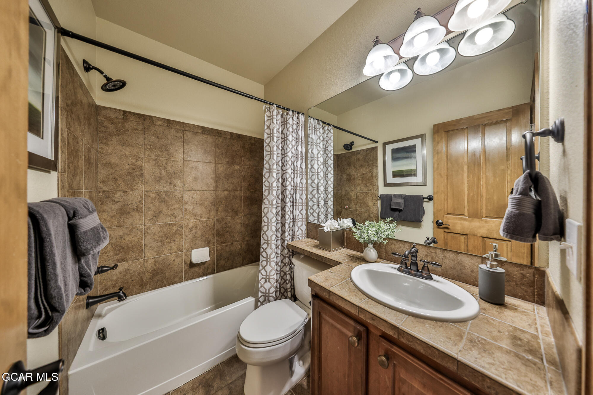 113 Summit Point Lane Granby, CO 80446 - Photo 24 of 43 a bathroom with a sink a toilet a mirror a bathtub and shower