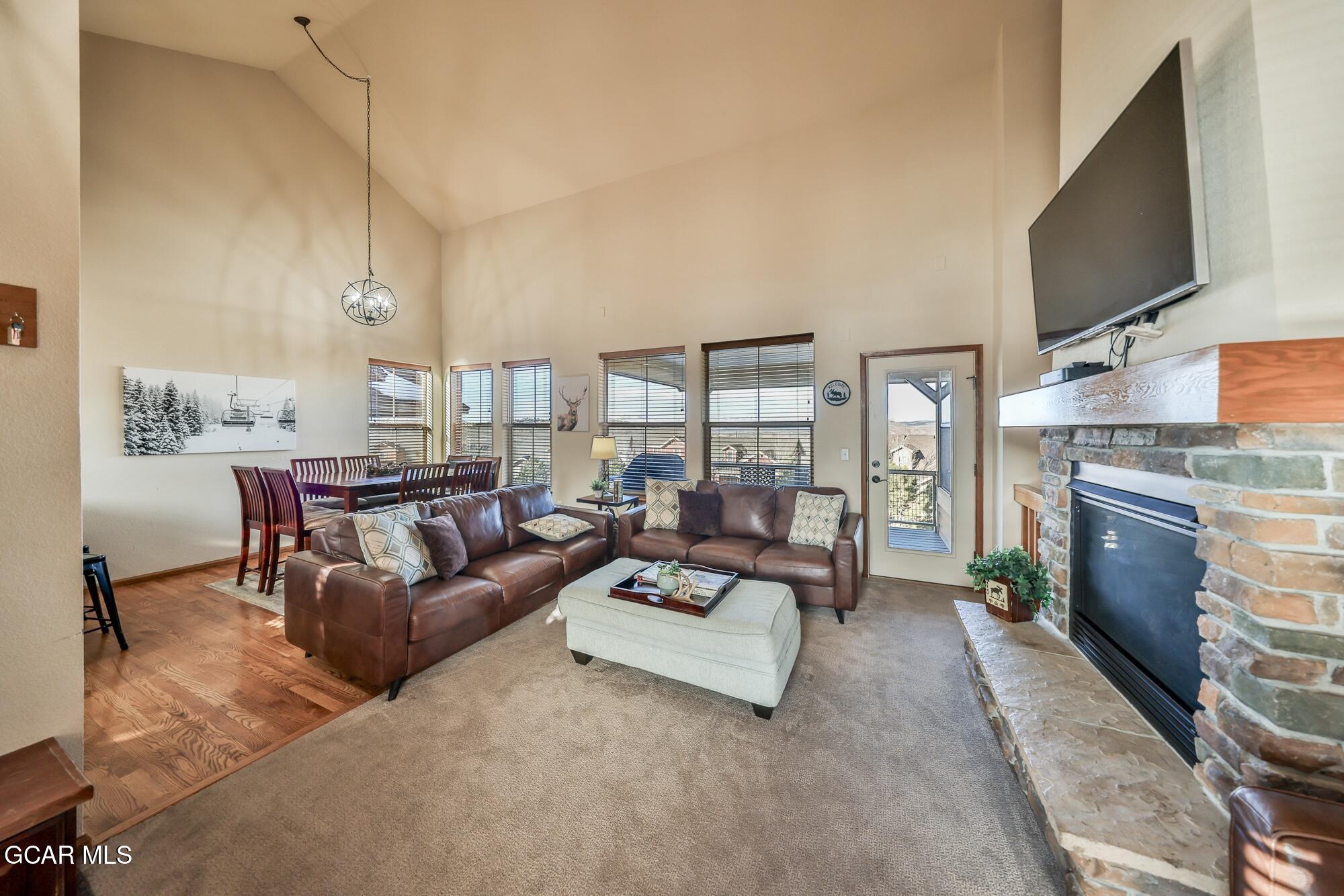 113 Summit Point Lane Granby, CO 80446 - Photo 3 of 43 a living room with furniture flat screen tv and a fireplace