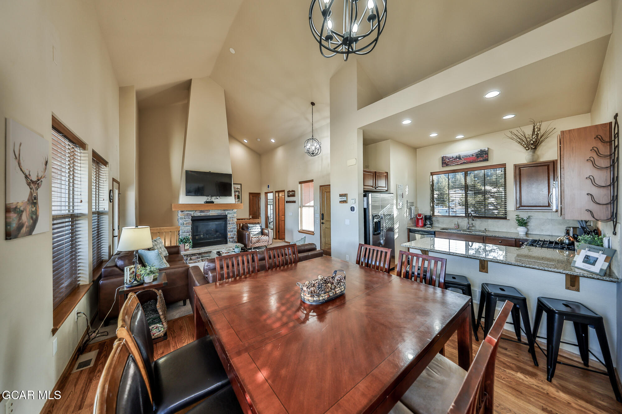 113 Summit Point Lane Granby, CO 80446 - Photo 6 of 43 a view of a dining room and livingroom with furniture wooden floor a chandelier