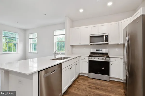 a kitchen with a refrigerator sink and microwave