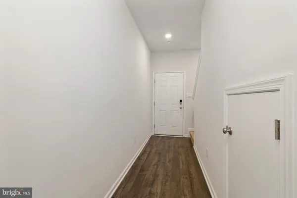 a view of empty room with window and ceiling fan