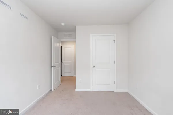 a bedroom with a bed tv and window
