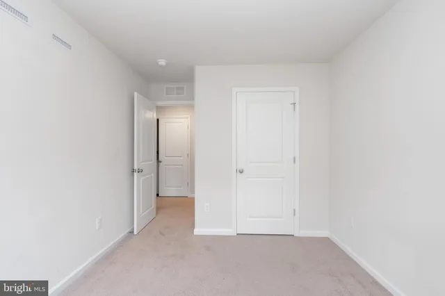 a view of an empty room with stairs
