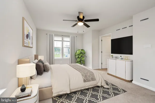 a bedroom with a bed and a large window