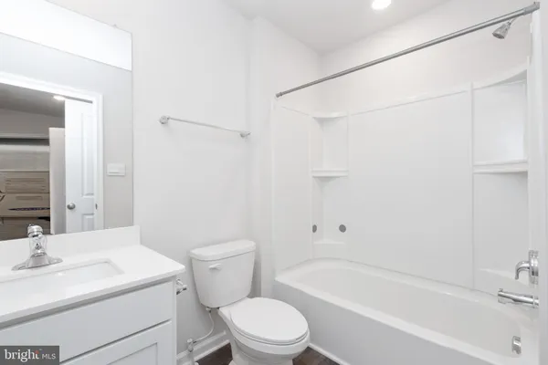 a view of bathroom with a sink mirror and toilet