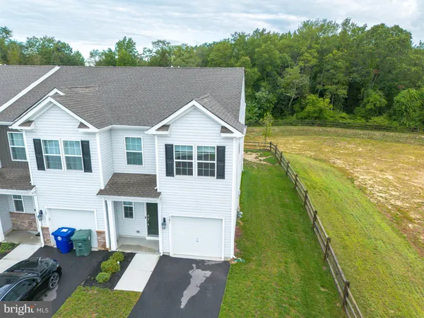 a kitchen with granite countertop wooden floors and white cabinets