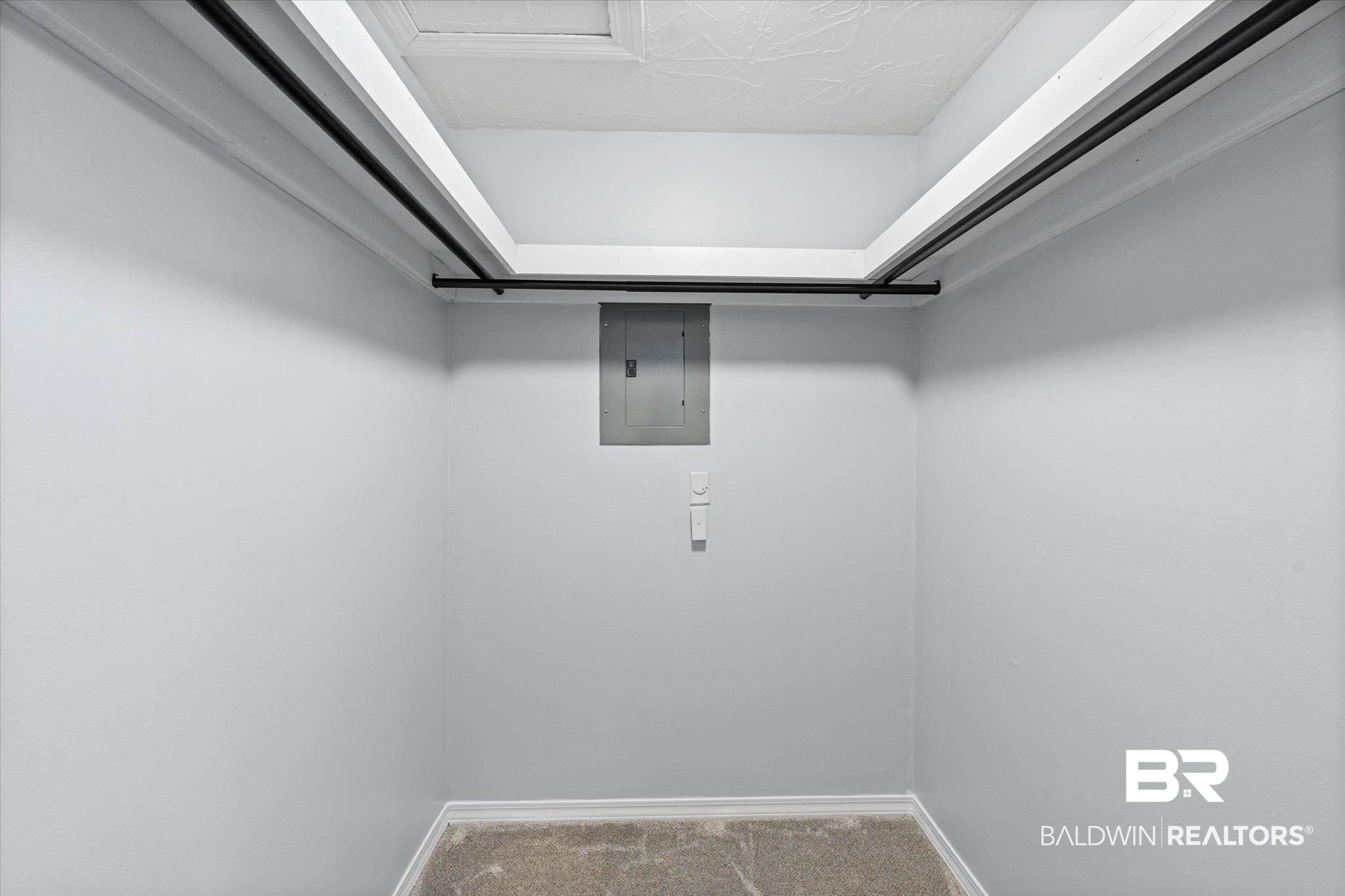500 Grant Street, Unit C210 Daphne, AL 36526 - Photo 20 of 26 Built-in closet rods with painted white shelf supports, light gray walls, and textured carpeting