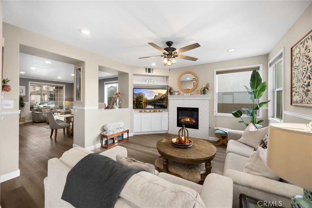 6861 Rio Grande Drive Eastvale, CA 91752 - Photo 11 of 36 a living room with furniture a fireplace and a large window