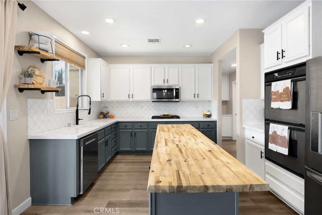 6861 Rio Grande Drive Eastvale, CA 91752 - Photo 13 of 36 a kitchen with granite countertop a sink stove and cabinets