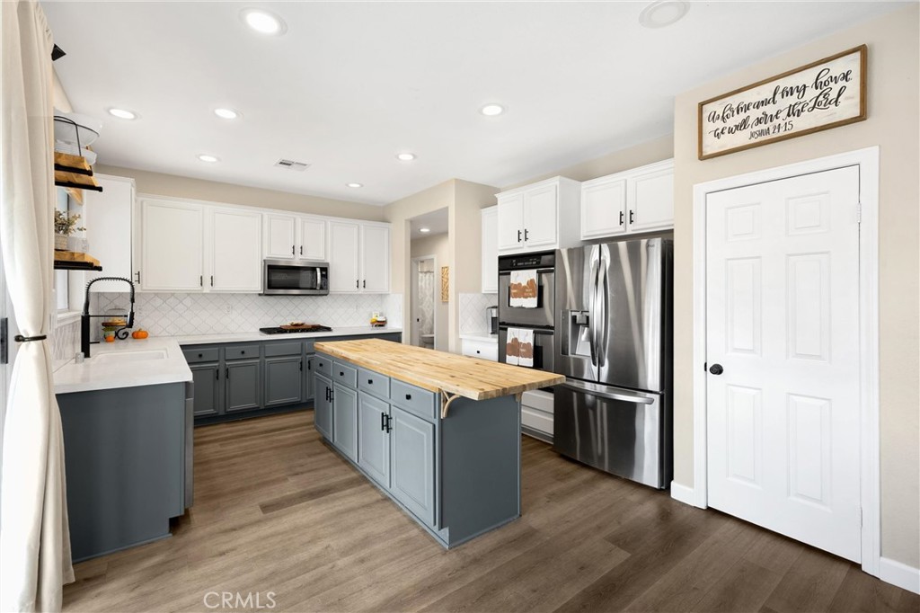 6861 Rio Grande Drive Eastvale, CA 91752 - Photo 15 of 36 a kitchen with stainless steel appliances a refrigerator sink and microwave
