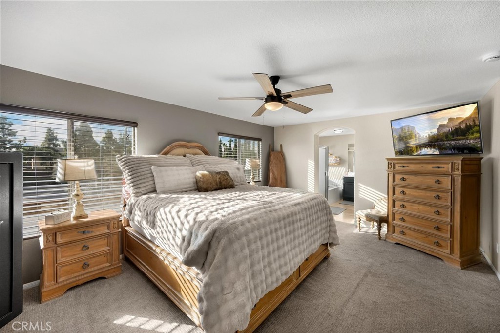 6861 Rio Grande Drive Eastvale, CA 91752 - Photo 17 of 36 a bedroom with a bed and a chandelier