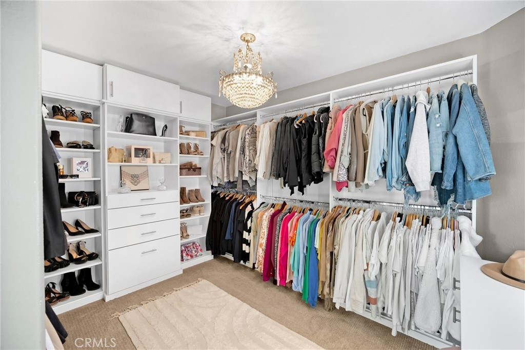 6861 Rio Grande Drive Eastvale, CA 91752 - Photo 20 of 36 a view of walk in closet with clothes and shoes