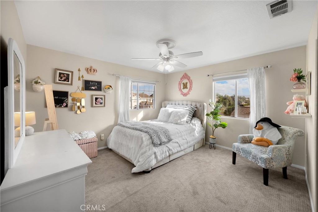 6861 Rio Grande Drive Eastvale, CA 91752 - Photo 21 of 36 a spacious bedroom with a bed and furniture