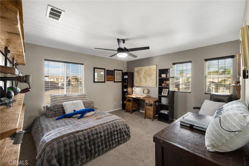 6861 Rio Grande Drive Eastvale, CA 91752 - Photo 23 of 36 a bedroom with a bed and wooden floor