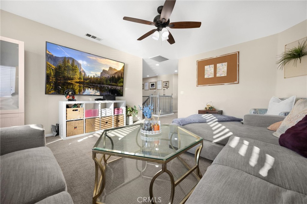 6861 Rio Grande Drive Eastvale, CA 91752 - Photo 25 of 36 a living room with furniture and a flat screen tv