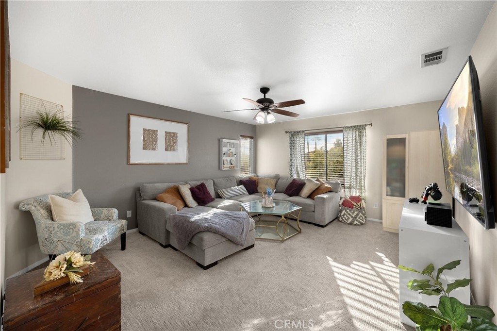 6861 Rio Grande Drive Eastvale, CA 91752 - Photo 26 of 36 a living room with furniture and a large window