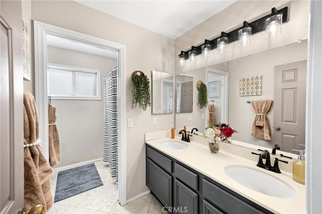 6861 Rio Grande Drive Eastvale, CA 91752 - Photo 27 of 36 a bathroom with a double vanity sink mirror and