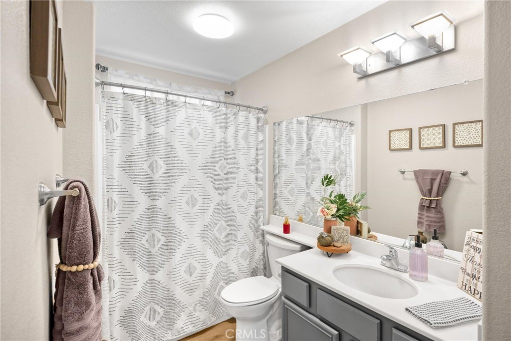 6861 Rio Grande Drive Eastvale, CA 91752 - Photo 29 of 36 a bathroom with a sink toilet and shower