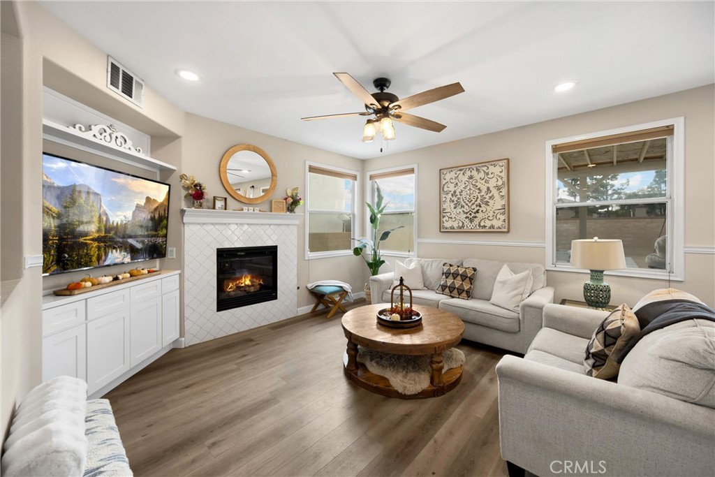 6861 Rio Grande Drive Eastvale, CA 91752 - Photo 9 of 36 a living room with furniture a fireplace and a large window