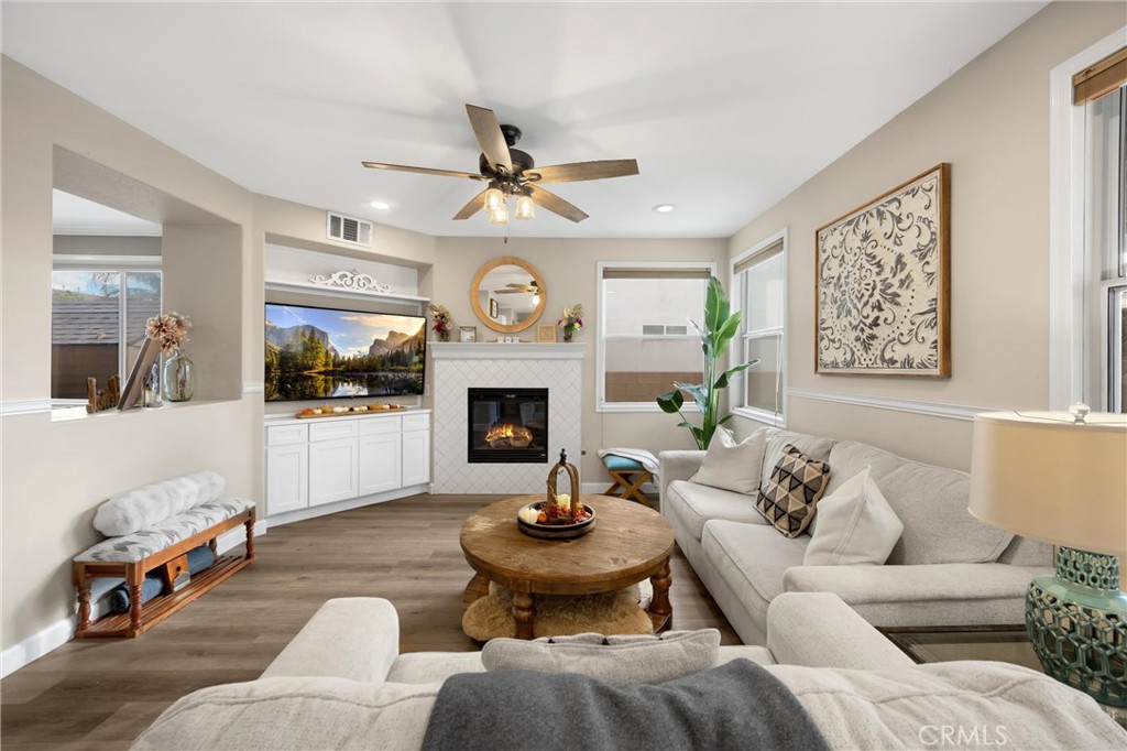 6861 Rio Grande Drive Eastvale, CA 91752 - Photo 10 of 36 a living room with furniture a fireplace and a large window